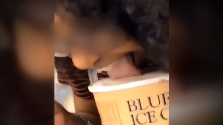Did a woman lick ice cream at a store?